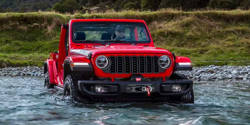 A red Wrangler fording deep water